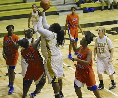 Image: Lady Gladiator Cory Chance(33) goes back up with a rebound against a Dallas Gateway defender.