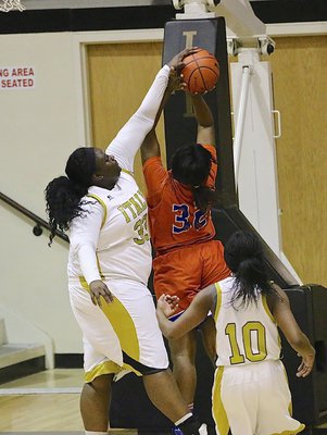 Image: Lady Gladiator Cory Chance(33) denies a Dallas Gateway shooter during first-half action.