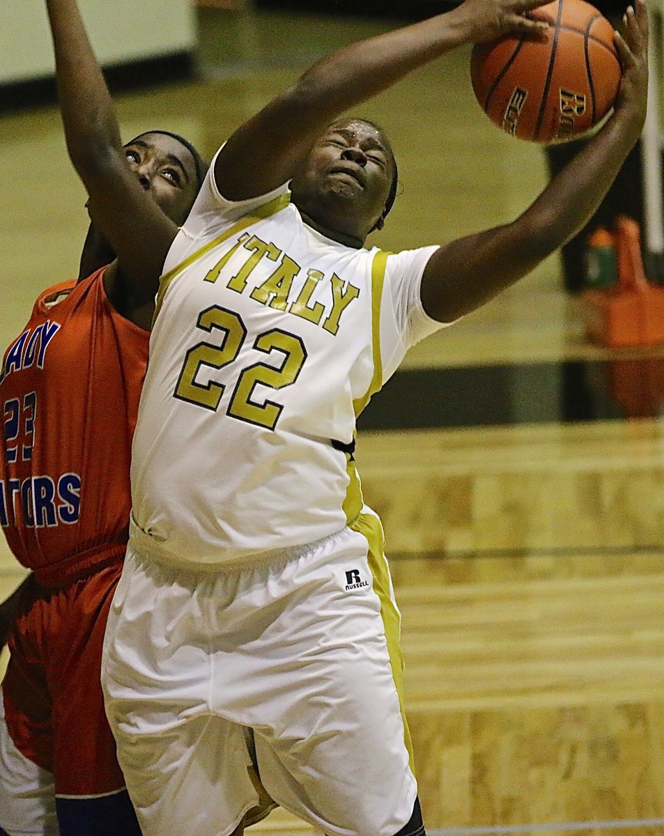 Image: Lady Gladiator Taleyia Wilson(22) grabs an offensive rebound after a missed free-throw and then powers a shot back up.