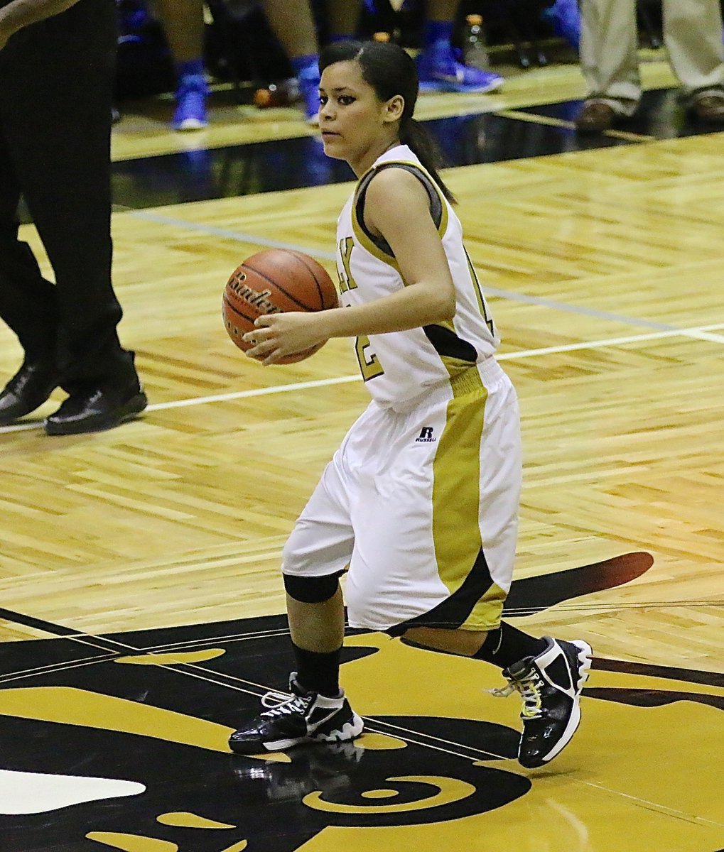 Image: Senior Lady Gladiator Alex Minton(12) brings the ball across mid court with her eyes up looking for an open teammate.