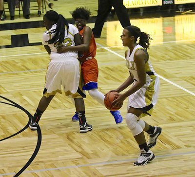 Image: Lady Gladiator Taleyia Wilson(22) sets a tremendous screen allowing teammate Emmy Cunningham(2) to knock down one of her four three-pointers against Dallas Gateway.