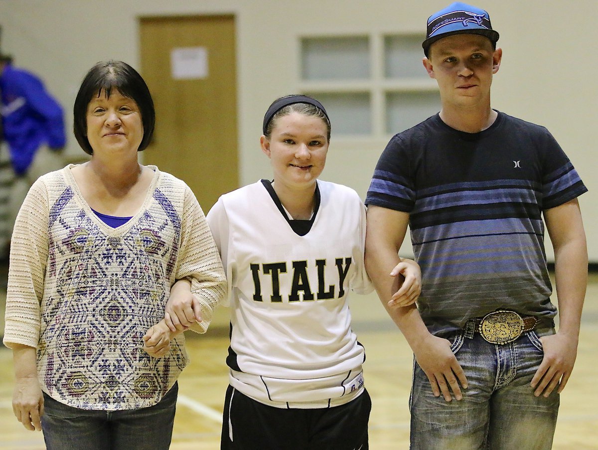 Image: Lady Gladiator senior Tara Wallis(4) is honored at halftime during 2015 Senior Night while being escorted by her mother Lori Wallis and her cousin Clay Gilbert.