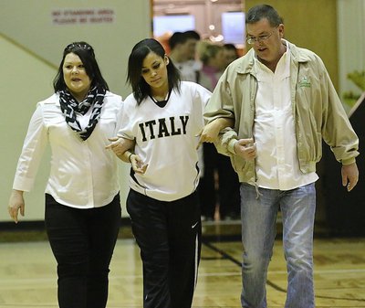 Image: Lady Gladiator senior Alex Minton(12) is honored at halftime during 2015 Senior Night while being escorted by her mother Wendi Minton and her grandfather Todd Johnston.