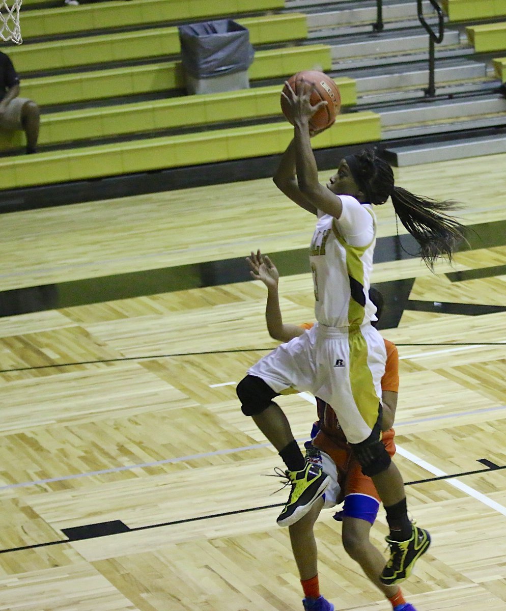 Image: Kortnei Johnson(3) soars to the rim to finish the fast break for the Lady Gladiators.