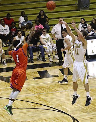 Image: Junior Gladiator Ryan Connor(11) takes a three-pointer from the top of the key.