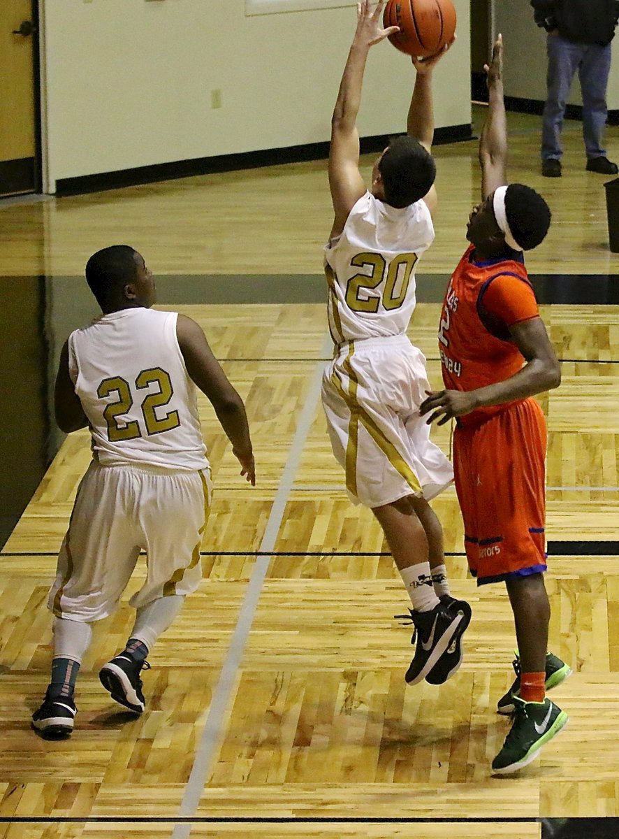 Image: Freshman Gladiator Kyle Tindol(20) gets up a shot from under the basket.