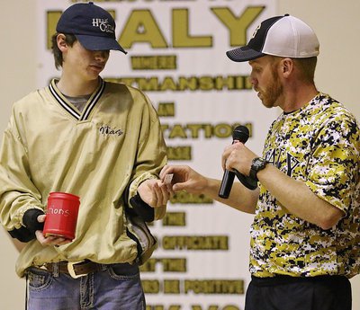 Image: Injured Gladiator Ty Windham still manages an assist to head baseball coach Jon Cady during the baseball team’s raffle fundraiser. Windham will be in the pitching rotation this season.