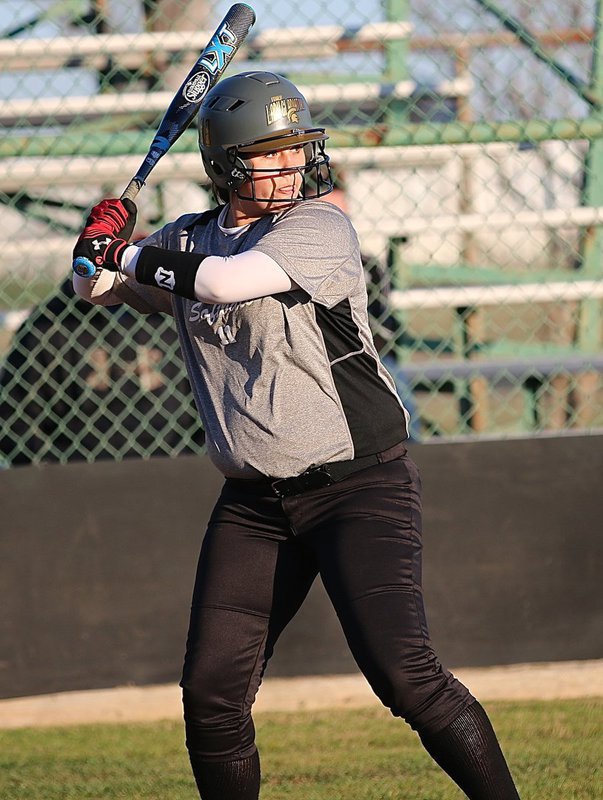 Image: Lady Gladiator Jenna Holden(11) takes a turn at bat and earns a walk to get on base.