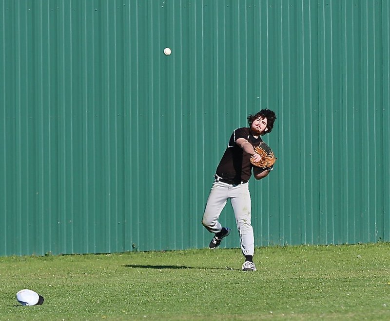 Image: Land Ho! Left fielder Kyle Fortenberry hurries the ball back into the sandy infield.