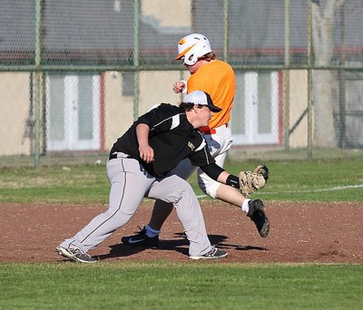 Image: Third-baseman John Byers tries to tag an Avalon player floating by.