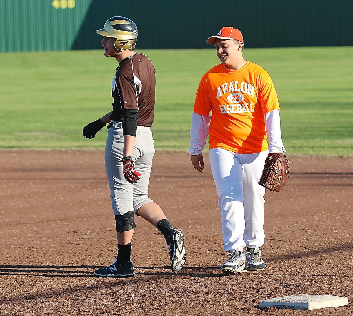 Image: Italy’s Micah Escamilla enjoys friendly competition with Avalon’s first-baseman.