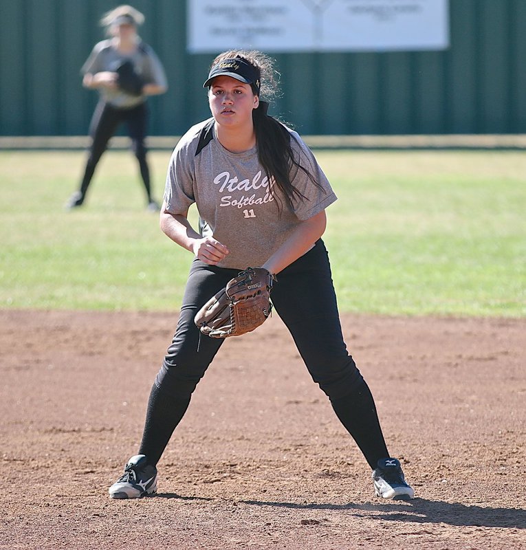 Image: Lady Gladiator first-baseman Jenna Holden(11) is tuned in during the pitch.