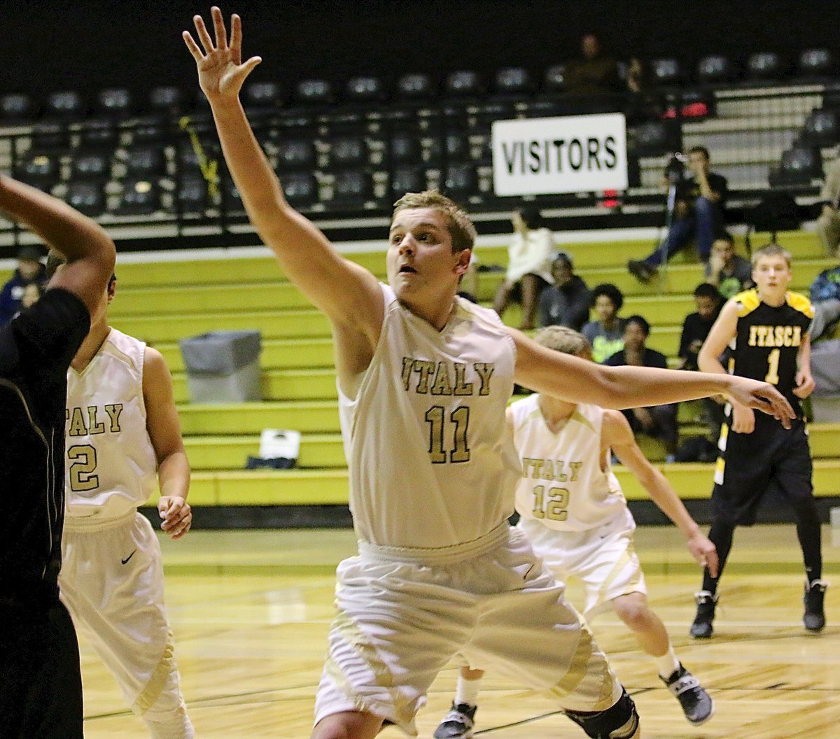 Image: JV Gladiator James Walton(11) closes out on an Itasca shooter.