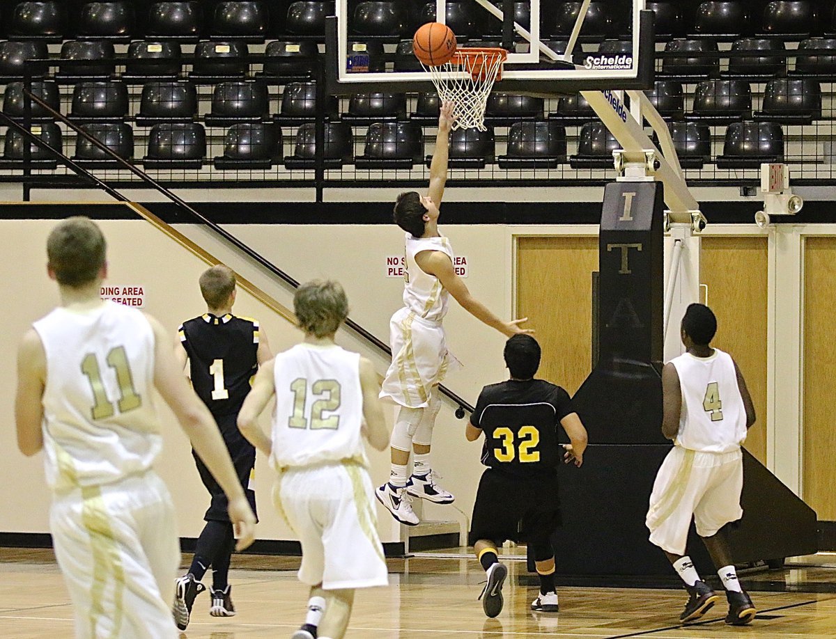 Image: JV Gladiator Gary Escamilla(2) tries to finish the fast break against Itasca.