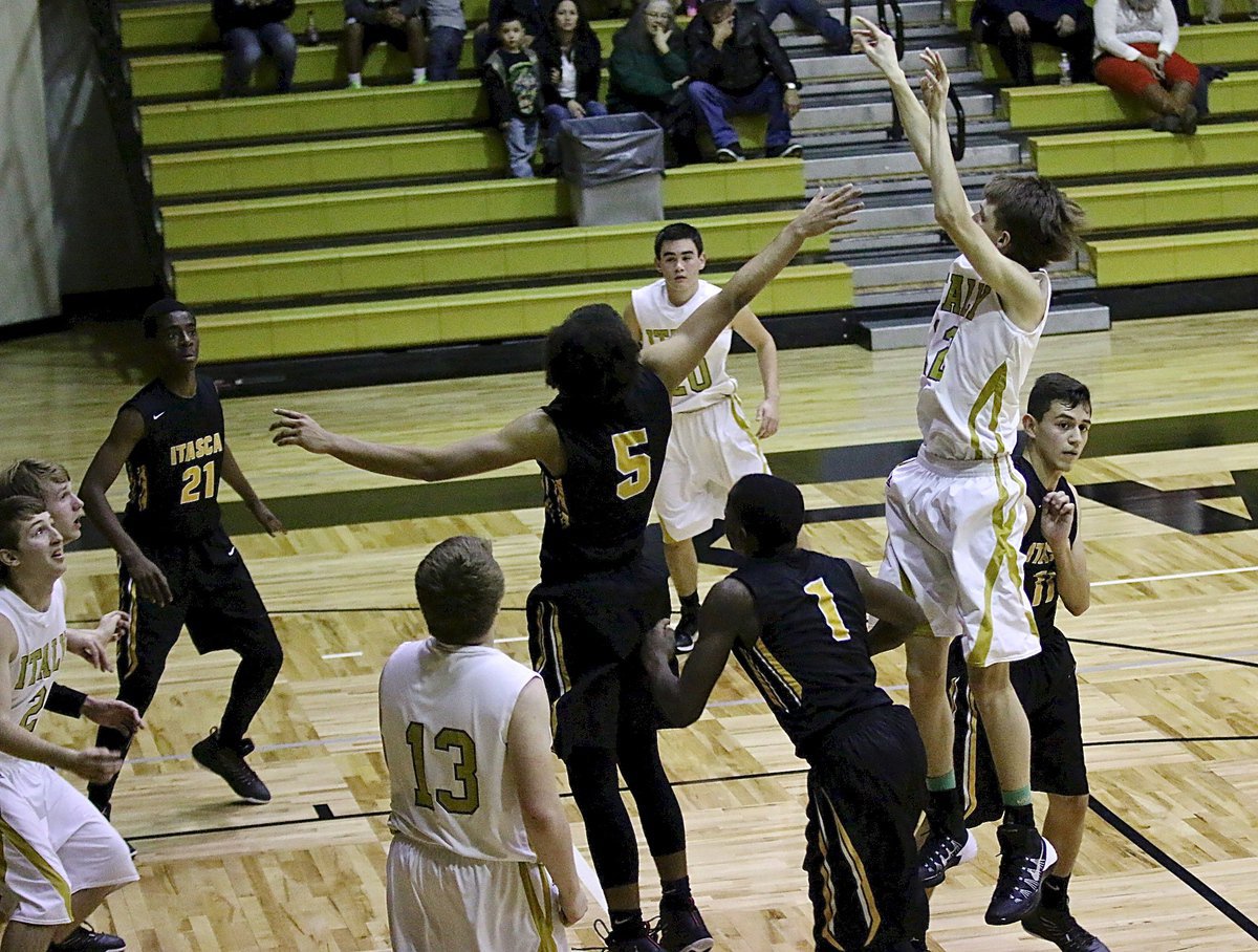 Image: Ty Windham(12) enters the fray and quickly knocks down a jumper for the Gladiator cause.