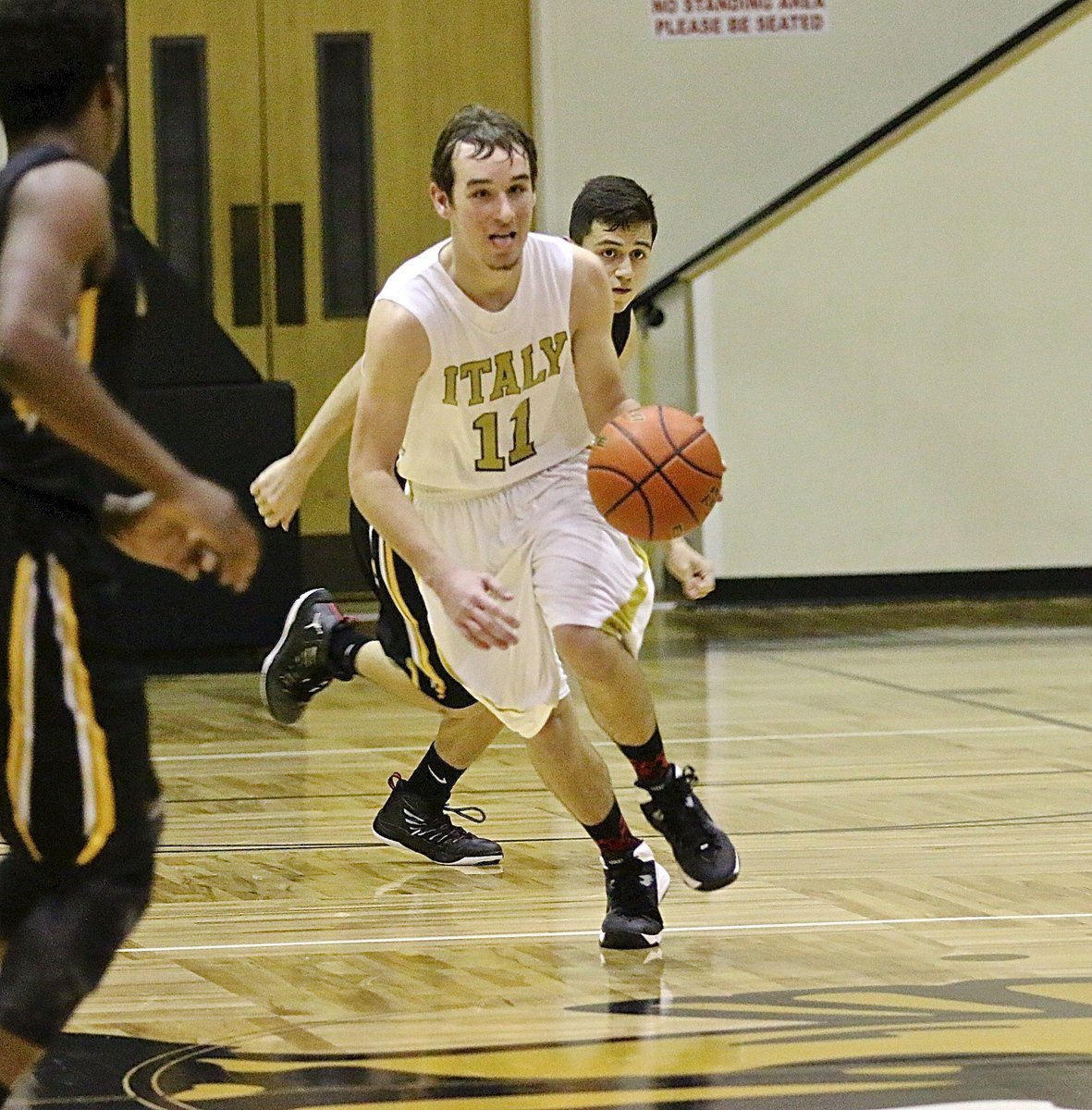 Image: Italy junior Ryan Connor(11) pushes the ball across mid court to the keep the offensive pressure on Itasca.