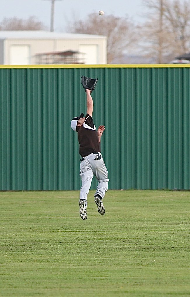 Image: Gladiator Levi McBride chases after a popup that is hit into the right field gap.