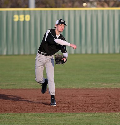 Image: Junior Ryan Connor takes a turn at short and later throws a Cougar runner out on a play to first-base.