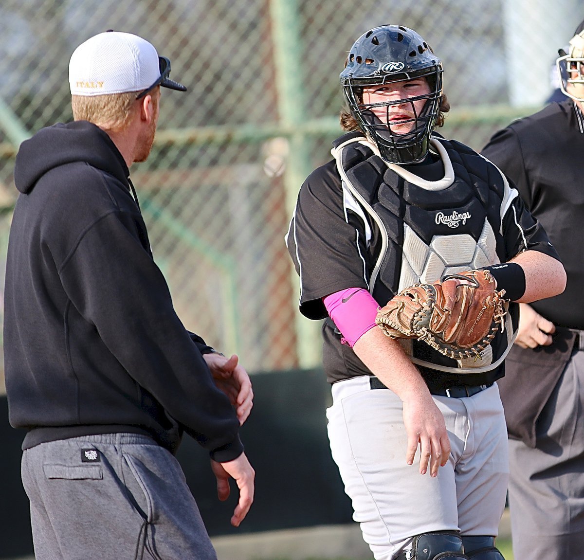 Image: Before the first pitch, Gladiator head coach Jon Cady goes over the signal calls with catcher Tyler Vencill.