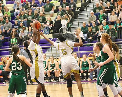 Image: Janae Robertson(5) and teammate Taleyia Wilson(22) extend for an offensive rebound with Wilson making the snag and putting up a shot.