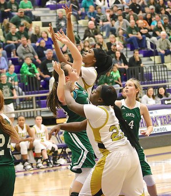 Image: Taleyia Wilson(22) passes to Lady Gladiator teammate Janae Robertson(5) who was open in the lane and scored with this shot at the front of the rim.