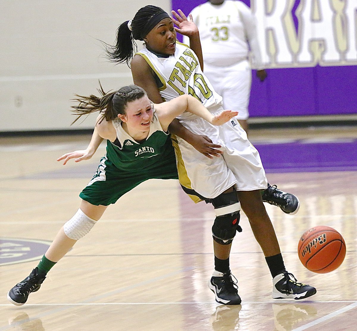 Image: Trying to cause a turnover, Italy’s K’Breona Davis(10) collides with a Santo ball handler.