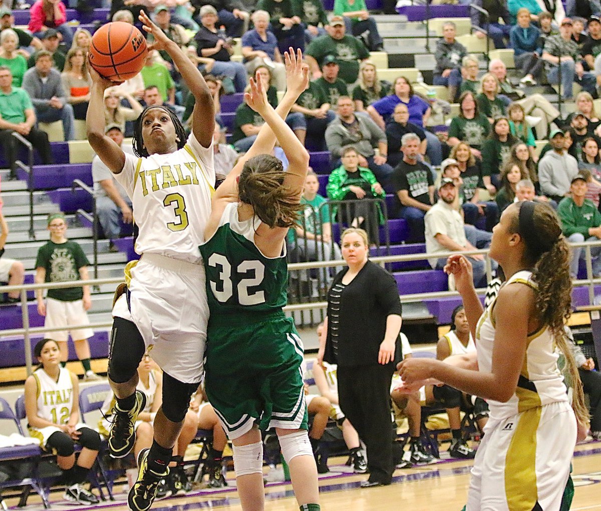 Image: Italy’s Kortnei Johnson(3) curls around a Santo defender on her way to the bucket. Johnson finished her final game as a Lady Gladiator hoop star with 17-points.