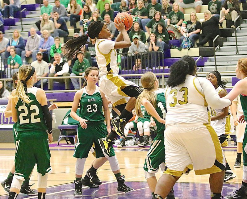 Image: The relentless Kortnei Johnson(3) penetrates the lane against the Santo defense.