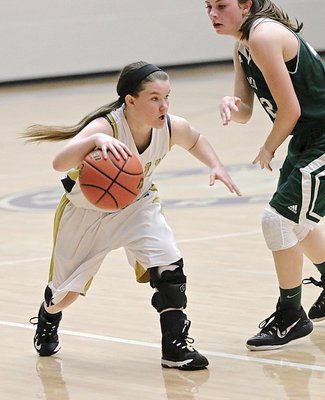 Image: Lady Gladiator senior guard Tara Wallis(4) dribbles past a Santo defender with Italy in a half court set.