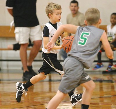 Image: Clifton is unable to stop Caleb Hyles(11) as he pushes the ball across mid court.