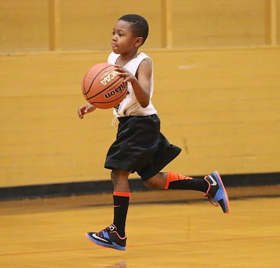 Image: Cory “Lucky” Johnson(3) keeps his eyes up while charging up court with the ball.