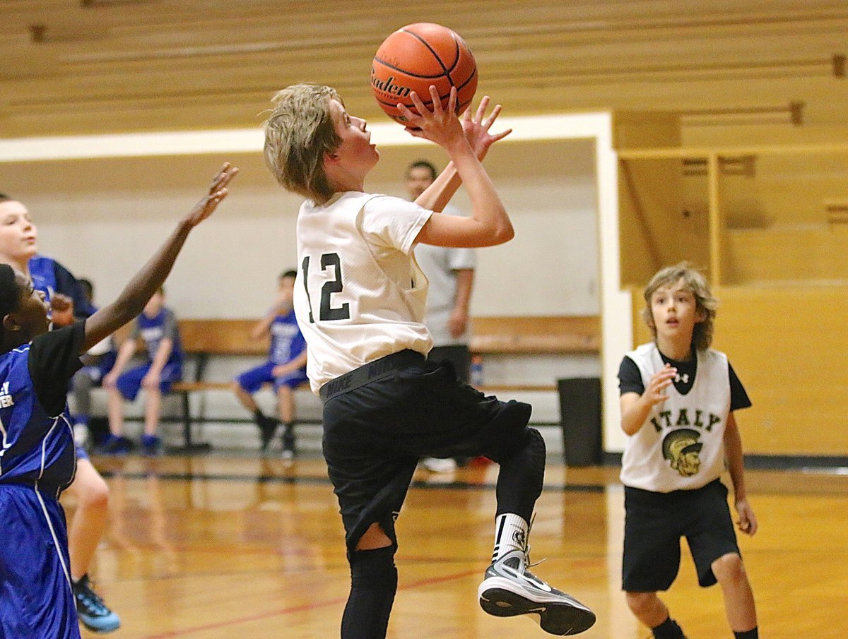 Image: Reece Janek(12) finishes the fast break for 2 of his 8-points against Whitney.