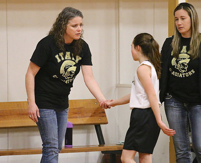 Image: Emily Janek(11) gets a much needed breather and hand shake from mother and coach Cortney Owen Janek and as Coach Shauna Steinmetz congratulates her player.