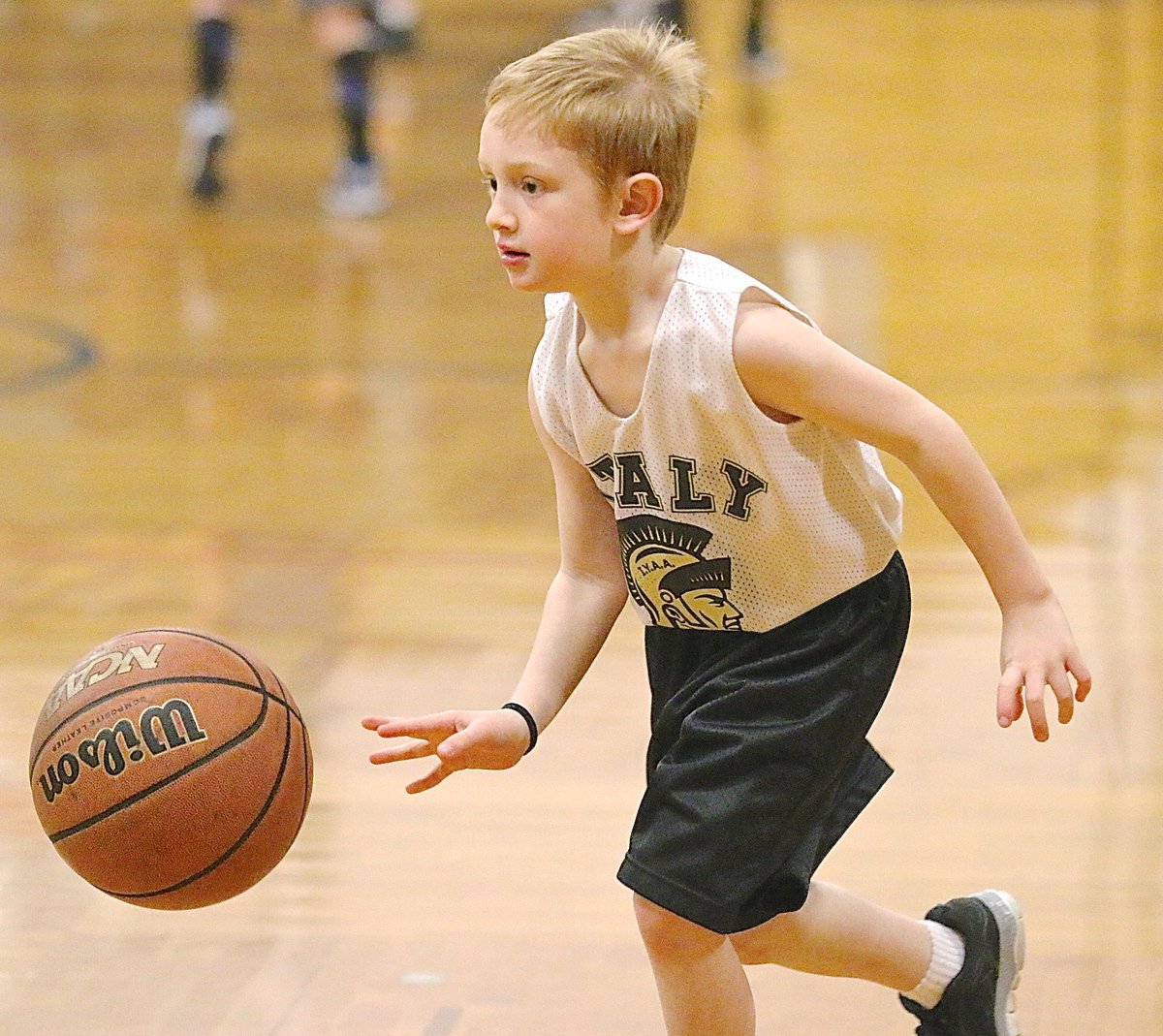 Image: Keevan Steward(5) practices dribbling the ball with eyes up during warm ups.