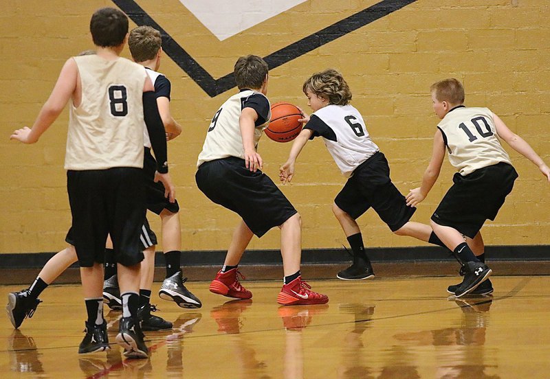 Image: Italy White’s Chase Hyles(6) steals the ball and dribbles away from Italy Gold’s Grant Hamby(9) and Ty Cash(10) during the 5th and 6th Grade Boys game.