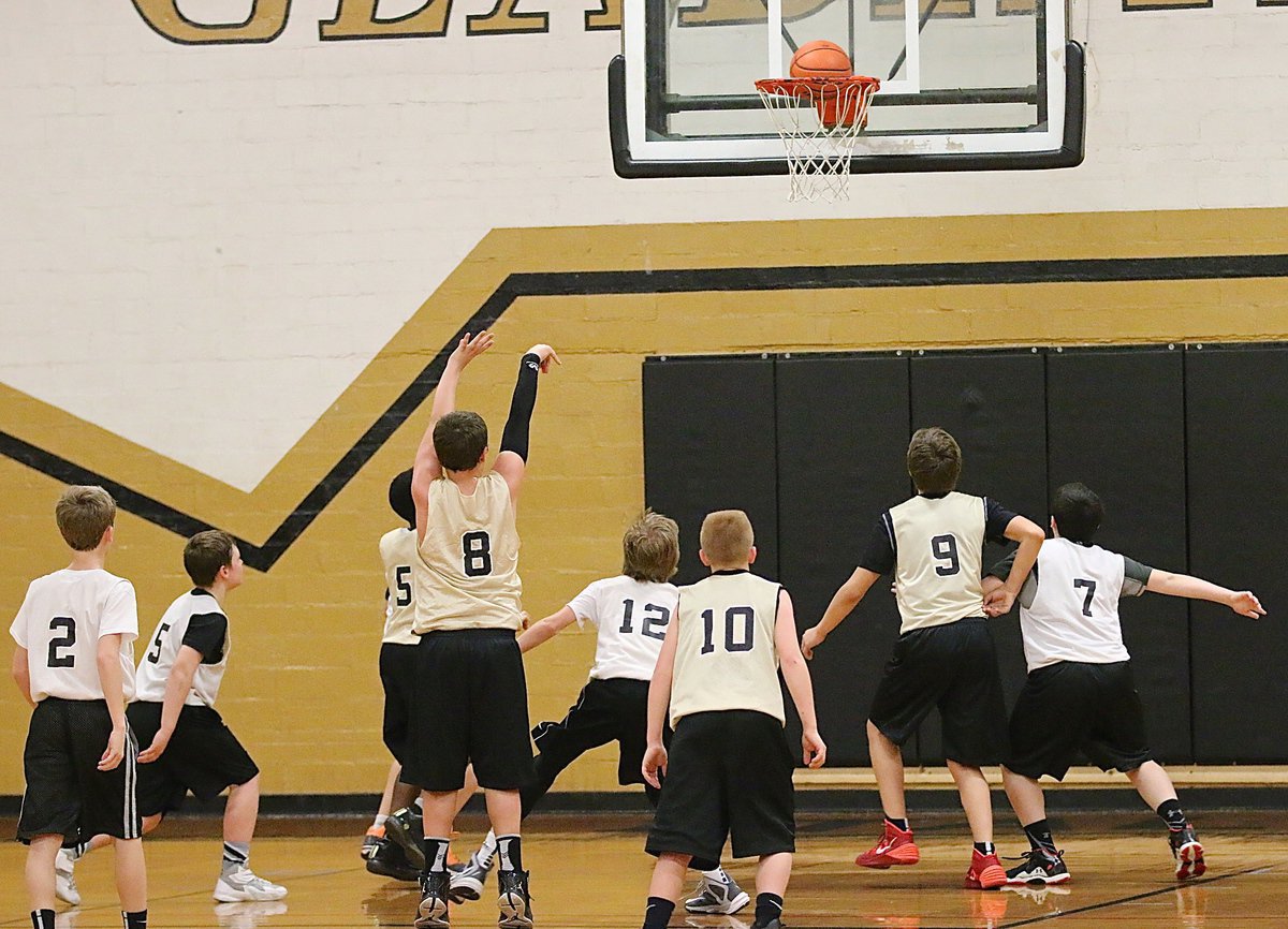 Image: Italy Gold’s Jayden Saxon(8) shows nice from from the foul line as both teams clammer for the rebound.