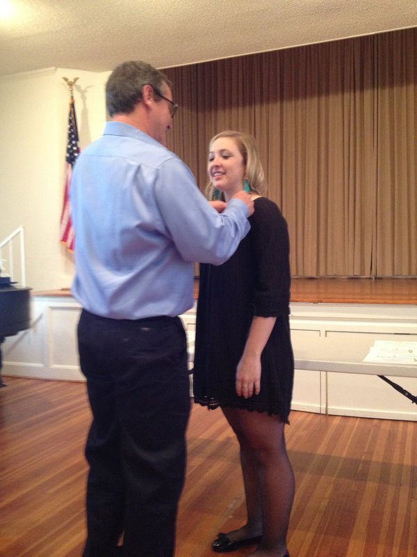 Image: Jaclynn is being pinned by her father, Russ Lewis.