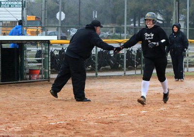 Image: Jaclynn Lewis is congratulated by Lady Gladiator head coach Tina Richards and assistant coach Johnny Jones as Lewis completes her homerun lap against Goliad.