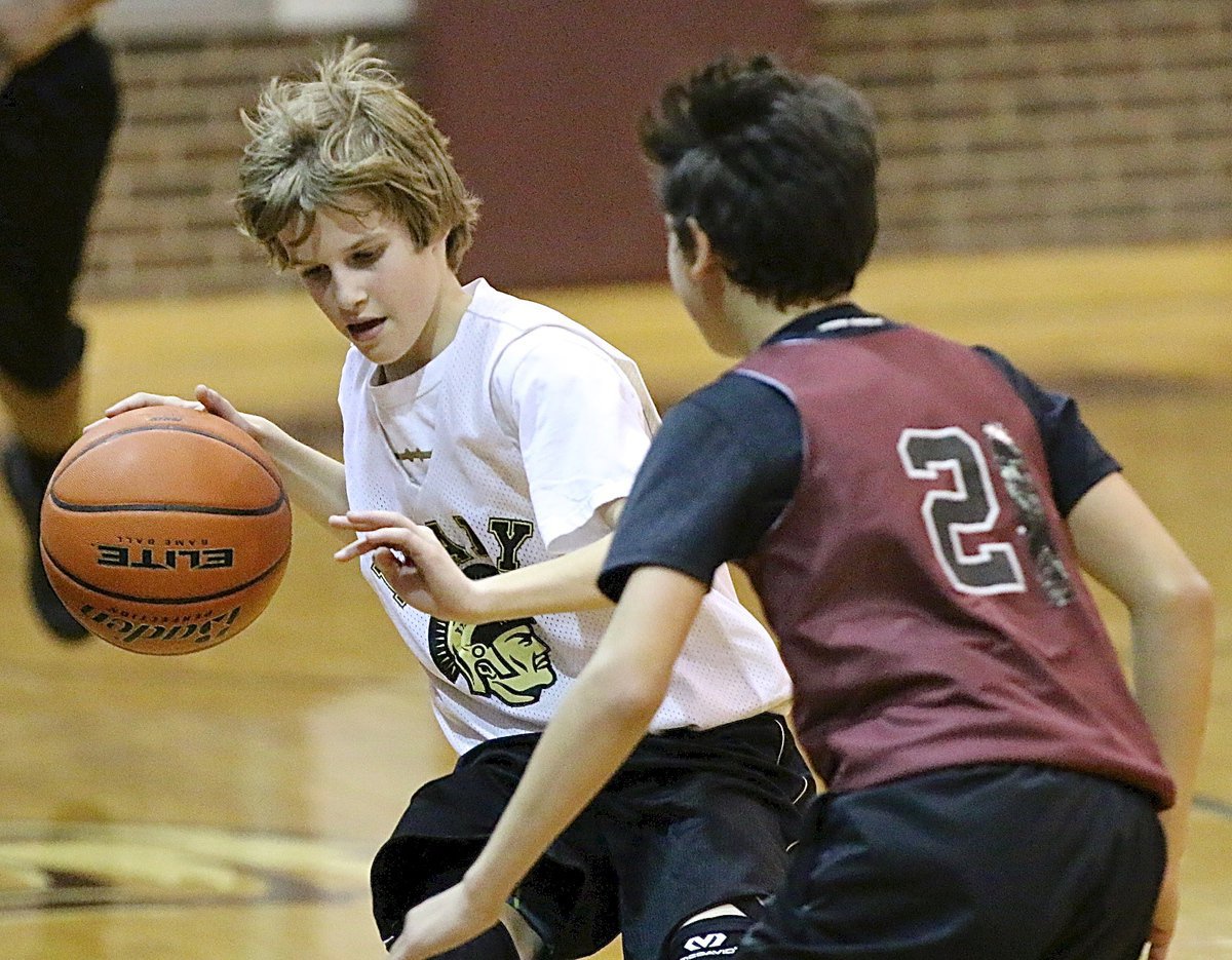 Image: Reese Janek(12) wards off a Hillsboro defender while bringing the ball up court for Italy.