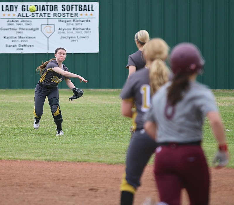 Image: Right fielder Tara Wallis(5) shoots the ball to first-base in hopes of slowing down Mildred’s offensive attack.