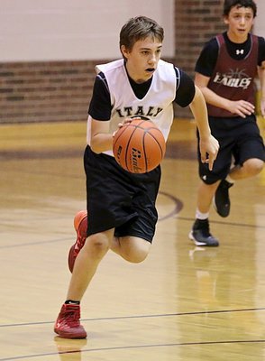 Image: Grant Hamby(9) hurries the ball up the floor showing his versatility for a big man.