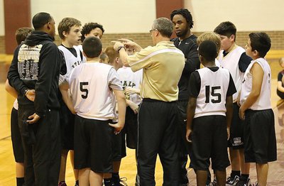 Image: Coaches Kyle Holley, Andre Speed and Jasenio Anderson huddle with their troops in crunch time.