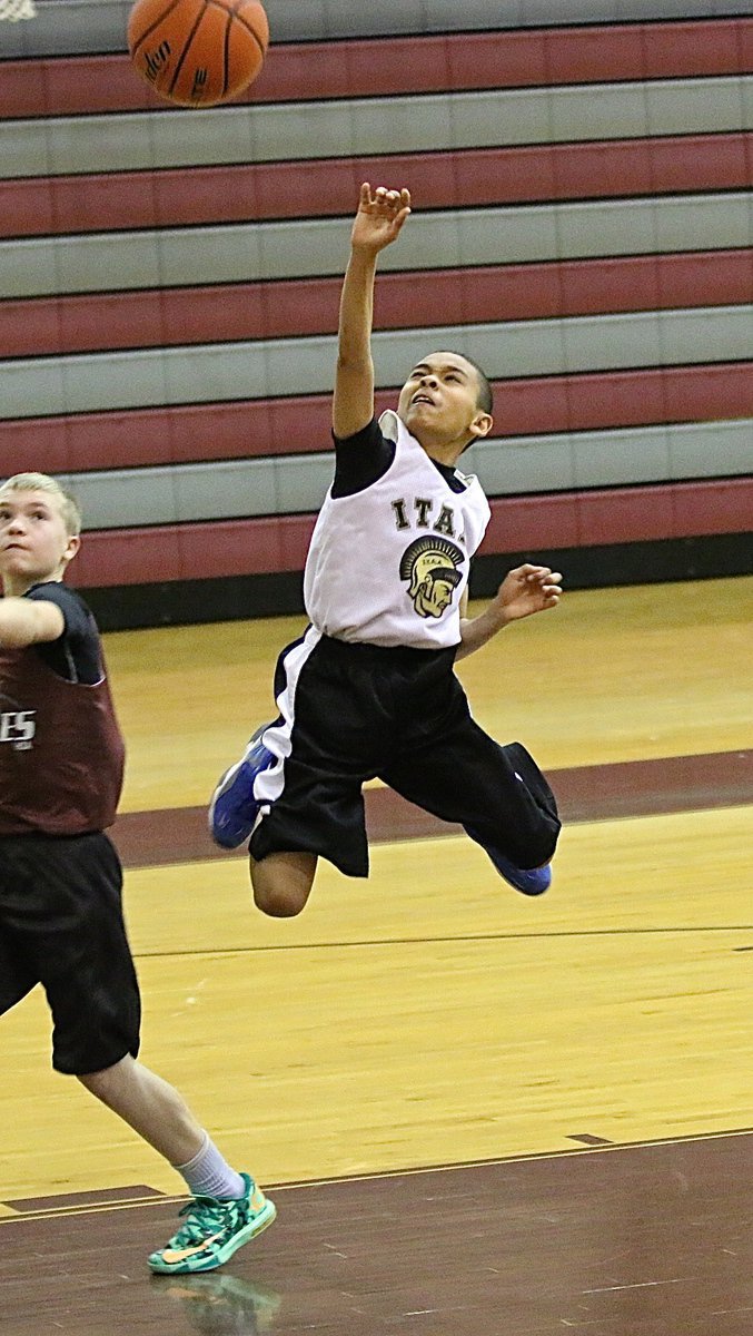 Image: Calvin Mays(4) draws a shooting foul while executing the fast break.