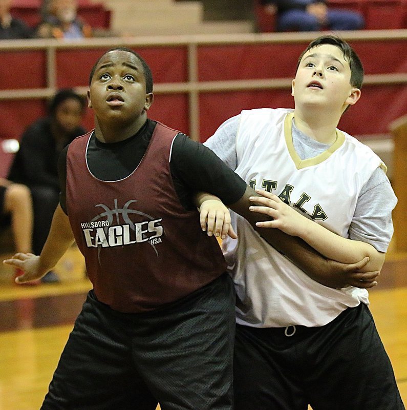 Image: Italy’s Rocklin Ginnett(5) battles for a rebound during a free throw attempt.