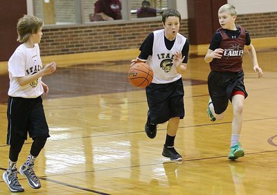 Image: With teammate Reese Janek(12) on the wing, Jayden Saxon(8) pushes the ball.