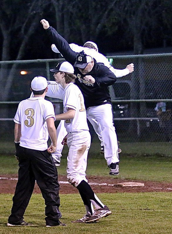 Image: Assistant baseball coach Jackie Cate gets up in the air with Levi McBride(1) in celebration of Italy’s 14-0 shutout win over Faith Family Academy.