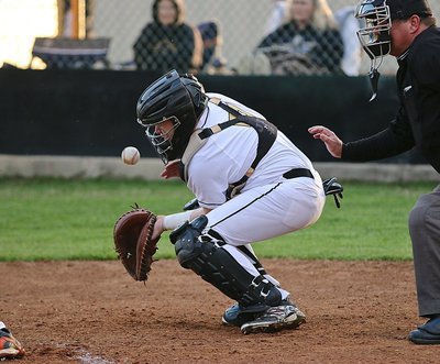 Image: Senior Gladiator catcher John Escamilla(7) keeps a low ball from getting past him.