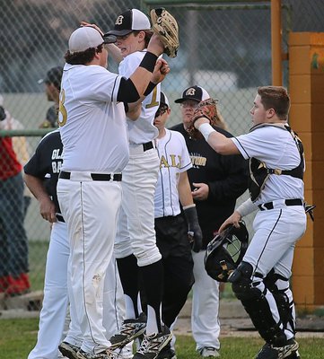 Image: Ty Windham(12) receives an arial luv bump from teammate John Byers(18) after Windham got Italy out of a jam with his second strikeout to start the game against Faith Family.