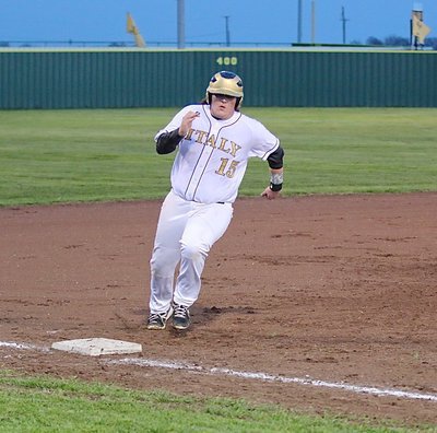 Image: Gladiator senior Tyler Vencill(15) races around third-base and hurries home to score a Gladiator run.
