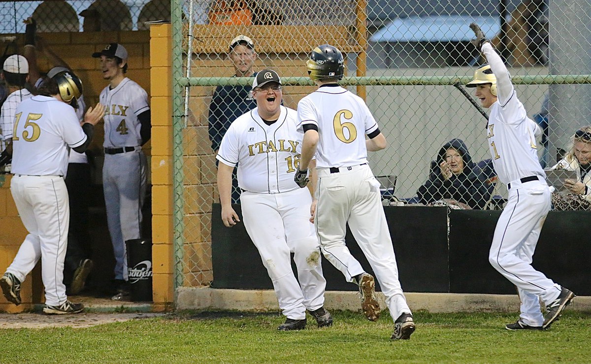 Image: Colin Newman(16) and Levi McBride(1) welcome Clayton Miller(6) back to the Gladiator dugout after Miller’s bunt turned into a trip around the bases.